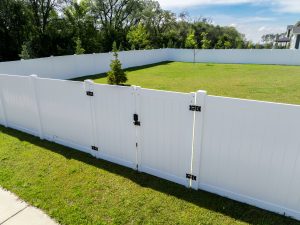 white vinyl fence with gate and black accent