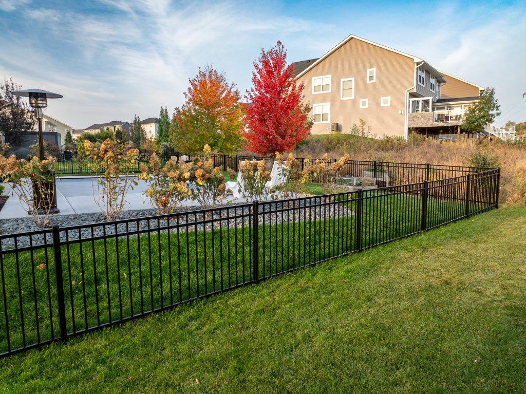 Ornamental fence with fall trees behind